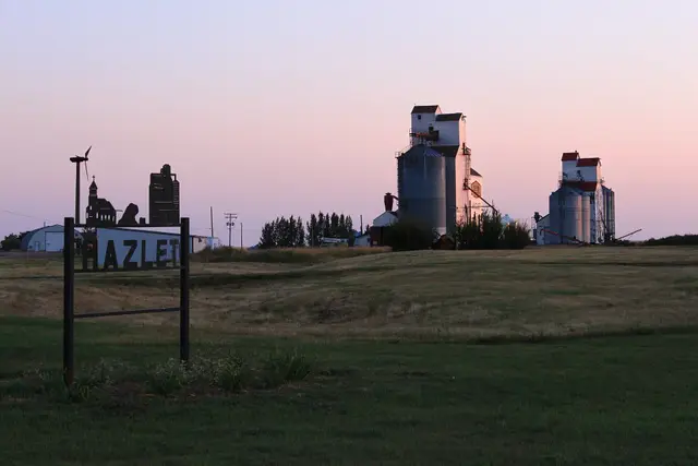 Grain elevators and town sign at dusk